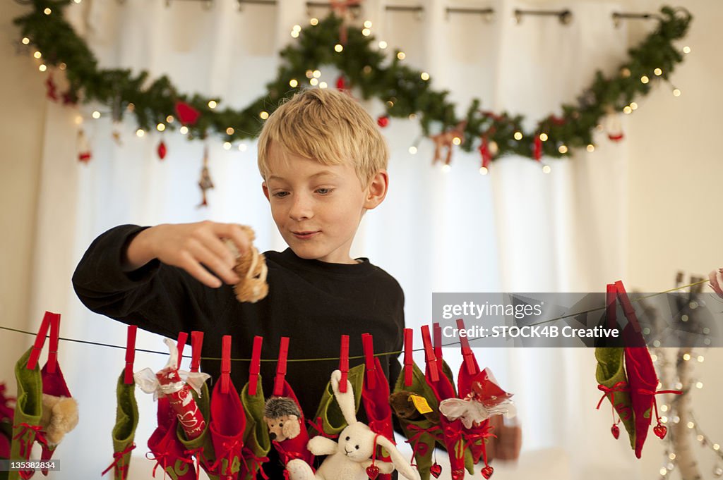 Boy holding present from Advent calendar