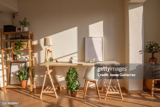 desktop for home office made by timber and sawhorses in a nordic style apartment. mockup frame empty copy space - bureaux photos et images de collection