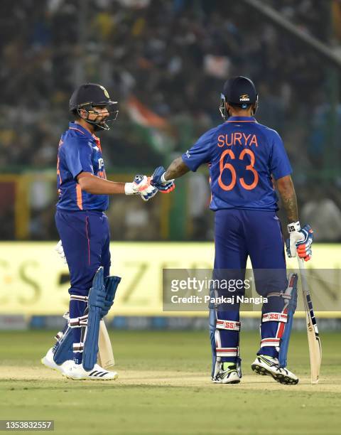Rohit Sharma of India and Suryakumar Yadav interact during the T20 International Match between India and New Zealand at Sawai Mansingh Stadium on...