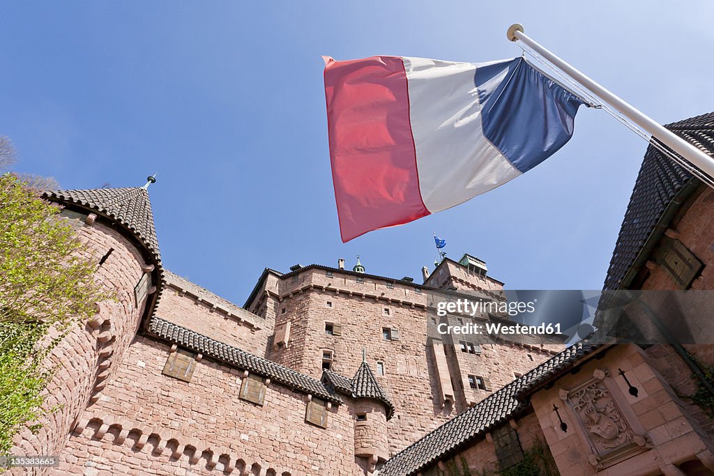 France, Alsace, Selestat, View of Haut-Koenigsbourg castle with French flag in foregound