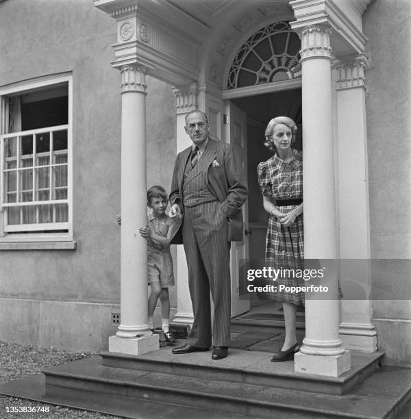 British businessman and Conservative Party politician Oliver Lyttelton , Minister of Production in Winston Churchill's war ministry, stands with his...