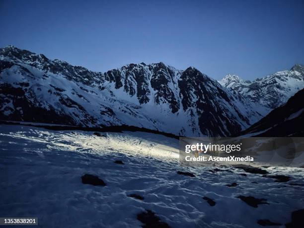 friends backcountry ski up snow slope before dawn - extreem skiën stockfoto's en -beelden