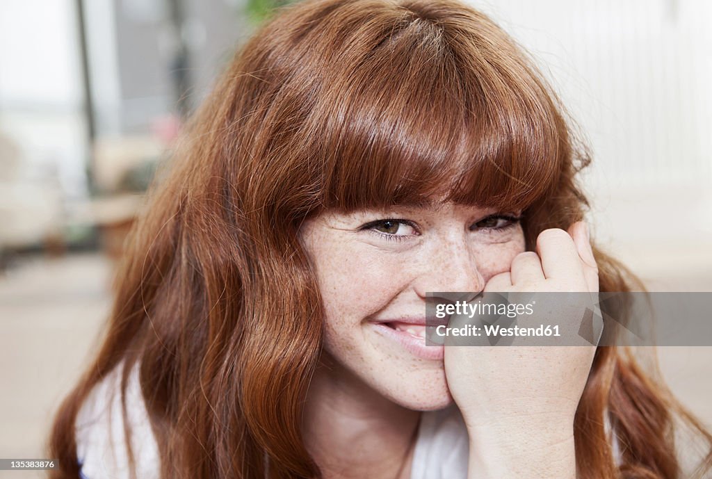 Germany, Berlin, Close up of young woman, smiling, portrait