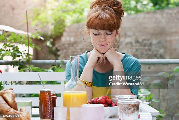 germany, berlin, young woman at lunch table, smiling - cruet stock pictures, royalty-free photos & images