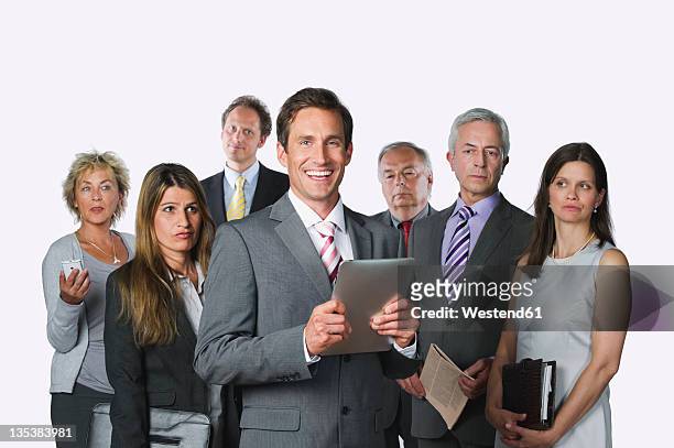 business people with digital tablet, file, diary, mobile phone and newspaper against white background - office politics stockfoto's en -beelden