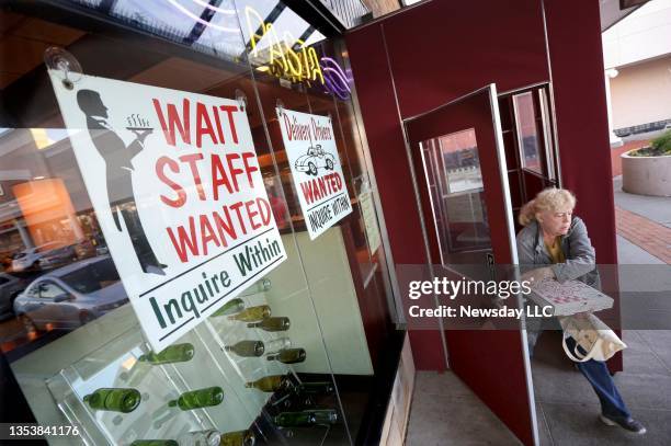 Sign outside the Pizzaiola pizzeria restaurant in North Babylon, New York advertises that positions were available for wait staff and delivery...