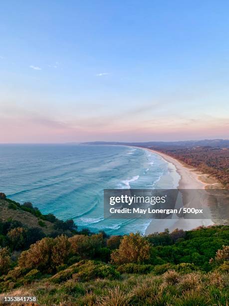 scenic view of sea against sky during sunset,byron bay,new south wales,australia - byron bay stock-fotos und bilder