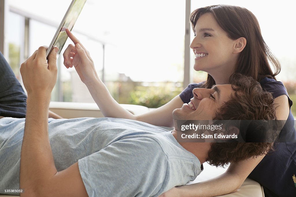 Couple using digital tablet together