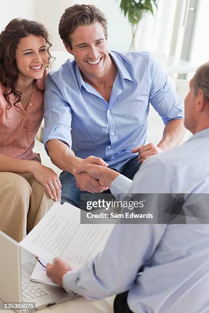 couple shaking hands with financial advisor - hello future are you there stock pictures, royalty-free photos & images