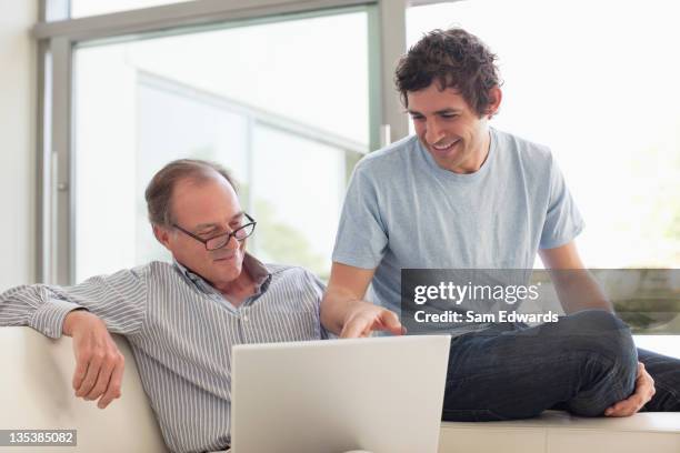 men using laptop together - old man son stock pictures, royalty-free photos & images