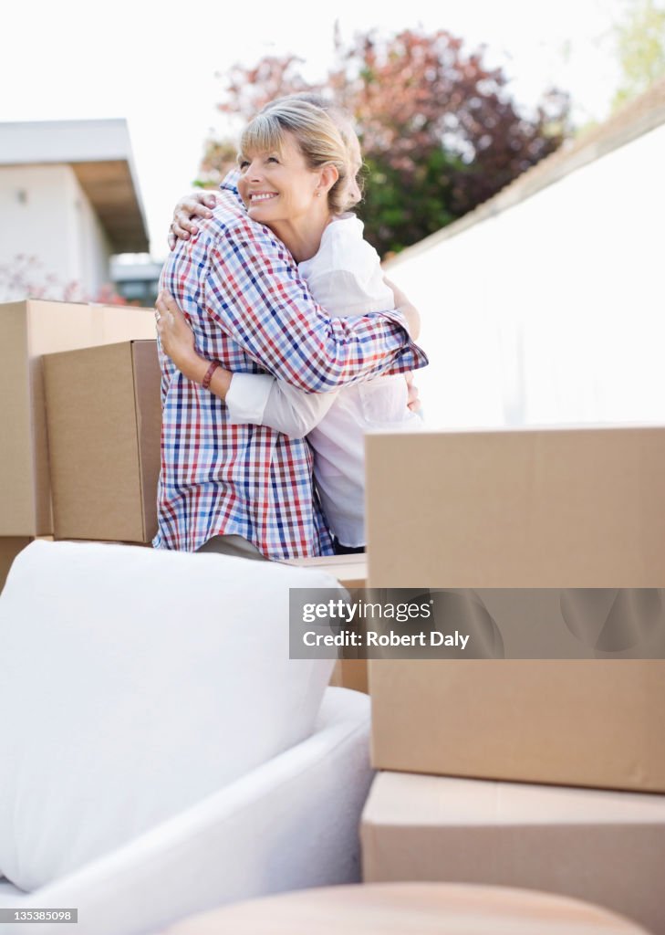 Couple hugging near moving boxes