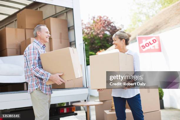 couple unloading boxes from moving van - old moving van stock pictures, royalty-free photos & images
