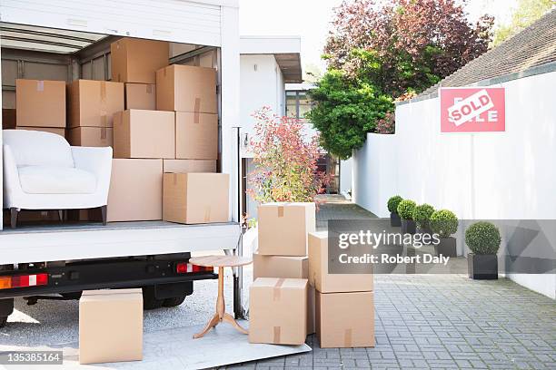 boxes on ground near moving van - relocation stock pictures, royalty-free photos & images