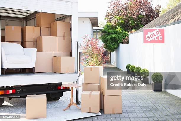 boxes on ground near moving van - moving van stock pictures, royalty-free photos & images
