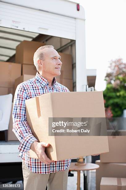 man unloading box from moving van - moving van stock pictures, royalty-free photos & images