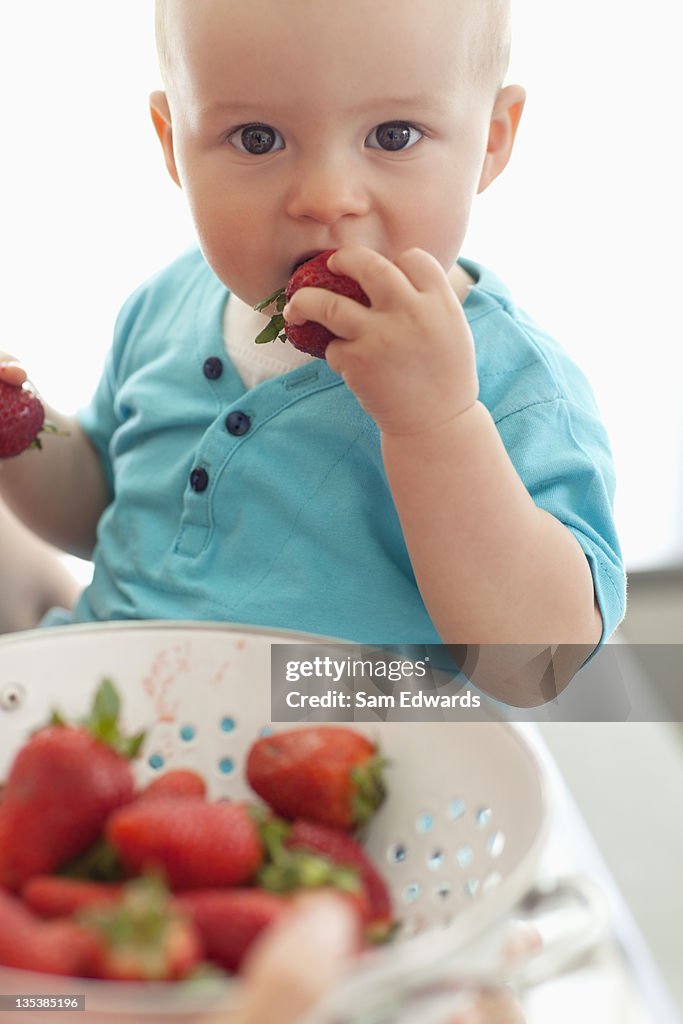 Baby eating strawberries