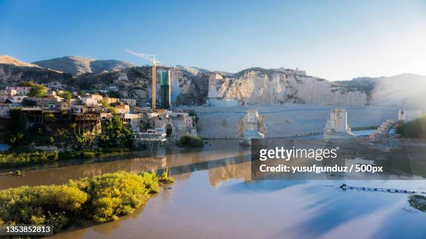 scenic view of lake by buildings against sky,hasankeyf,batman,turkey - the batman stock pictures, royalty-free photos & images