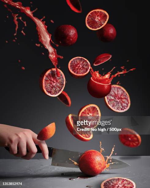 flying slices of red oranges - food mid air stock pictures, royalty-free photos & images