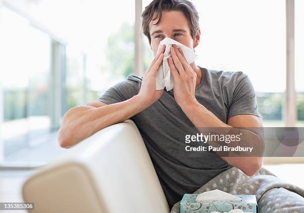 sick man blowing his nose - blowing nose stock pictures, royalty-free photos & images