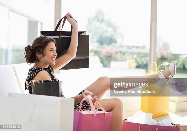 excited woman in living room with shopping bags - shopping excitement stock pictures, royalty-free photos & images