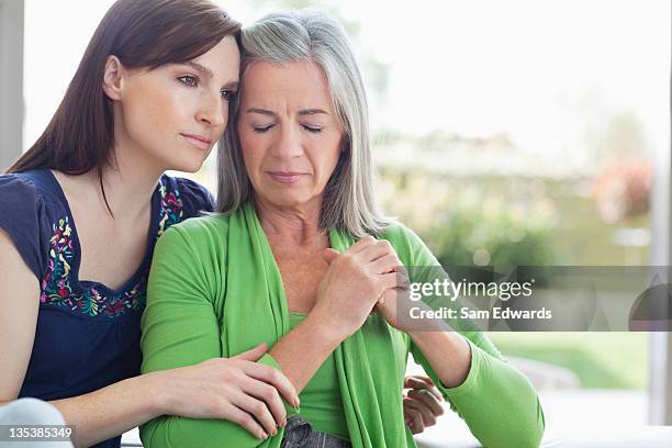 woman consoling sad mother - grief stock pictures, royalty-free photos & images
