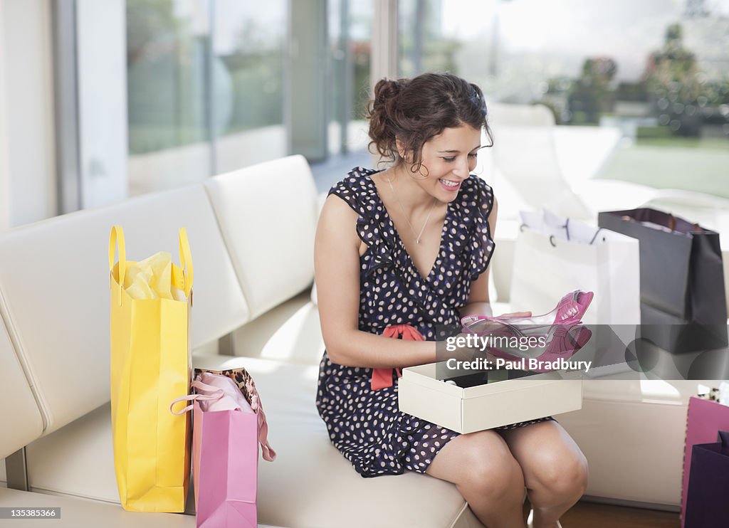 Excited woman taking shoes from box