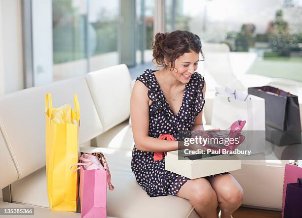 excited woman taking shoes from box - shoe box stock pictures, royalty-free photos & images