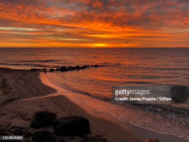 scenic view of sea against sky during sunset,a s esplanade,glenelg south,south australia,australia - james popple stock pictures, royalty-free photos & images