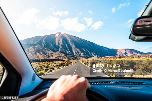 personal perspective of person driving on mountain road - inner views stock-fotos und bilder