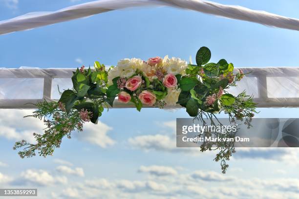 lush bouquet on outdoor wedding altar - wedding symbols stock pictures, royalty-free photos & images
