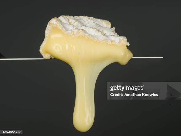 close up camembert cheese melting - camambert stockfoto's en -beelden