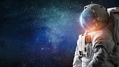 Astronaut in outer space. Spaceman with starry and galactic background. Sci-fi digital wallpaper
