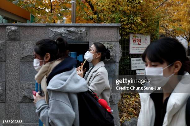 Mother look her daughter taking the College Scholastic Ability Test on November 18, 2021 in Seoul, South Korea. The annual College Scholastic Ability...