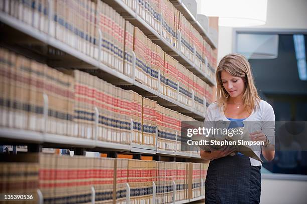 young businesswoman in law library - law books fotografías e imágenes de stock