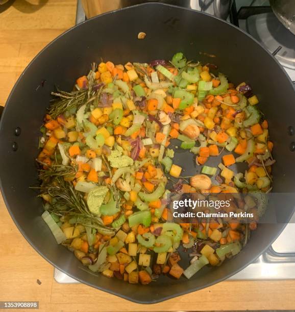 vegan mirepoix base for french casserole, rustic mix of organic vegetables, flavour base for stew of carrot, celery, and onion with garlic, rosemary and herbs, italian soffrito, diced vegan ingredients sautéed in butter and oil - mirepoix comida fotografías e imágenes de stock