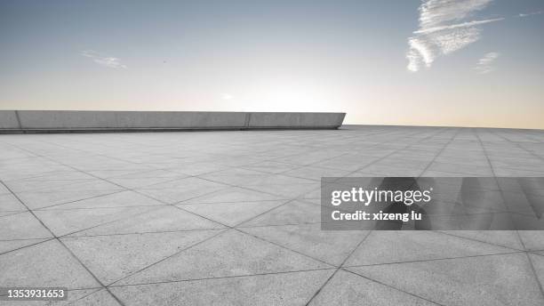 empty brick floor under clear sky - städtischer platz stock-fotos und bilder