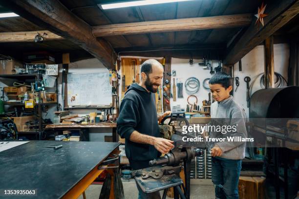 Father teaching his son how to sharpen a chainsaw