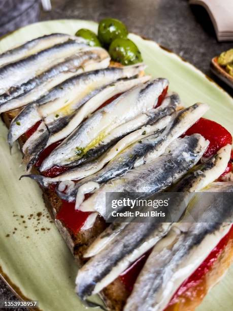 sprats sandwich decorated with tomato - anchovy fotografías e imágenes de stock