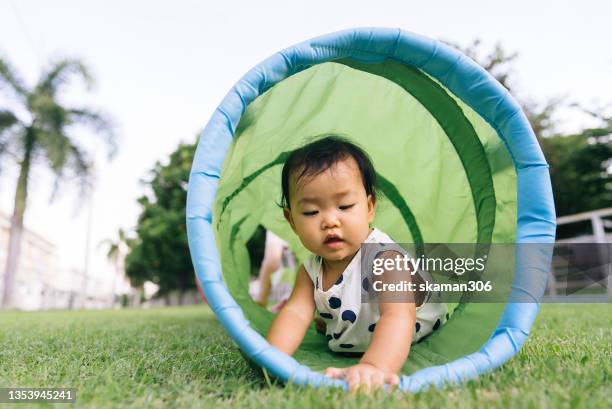 asian family mother and daughter cheerful  playing kid tube playground front yard at home domestic life - bébé jeu photos et images de collection