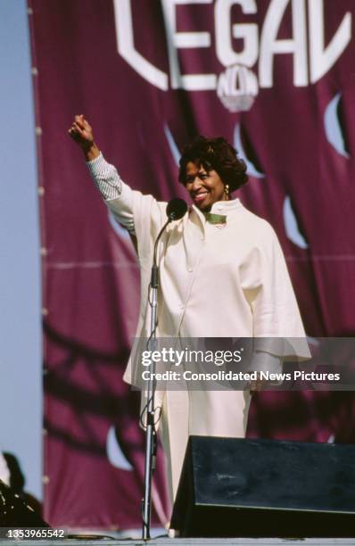 American politician and diplomat Carol Moseley Braun, a member of the Illinois House of Representatives, raises her fist as she addresses the March...