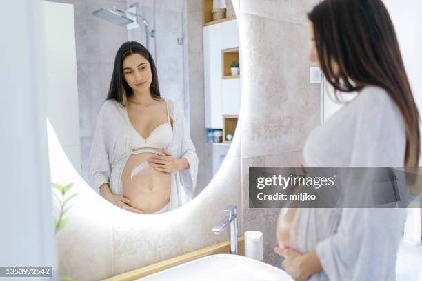 young woman enjoying being pregnant. - beauty treatment stockfoto's en -beelden