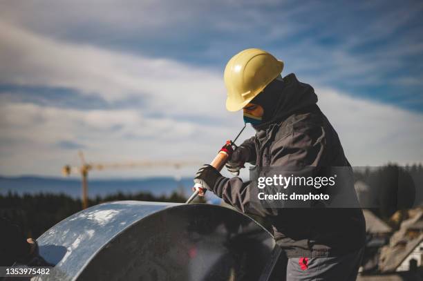 warehouse heating and cooling system installation - roof inspector stock pictures, royalty-free photos & images