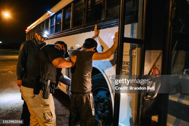 Texas state trooper and border patrol officer inspect a migrant involved in a smuggling case on November 17, 2021 in La Joya, Texas. The number of...