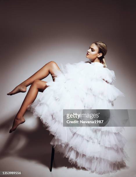 blonde woman wearing high fashion white dress - high fashion stock pictures, royalty-free photos & images