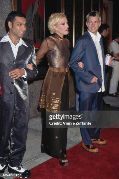 British-American musician Tony Kanal, American singer Gwen Stefani, and American drummer Adrian Young, members of American rock band No Doubt, attend...
