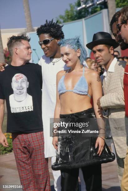 American drummer Adrian Young, American musician Gabrial McNair, American singer Gwen Stefani, wearing a light blue bikini top and black trousers,...