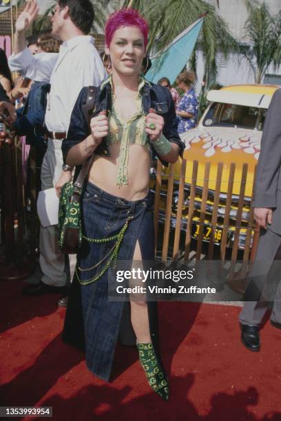 American singer Pink, with pink hair, attends the 2nd Annual Teen Choice Awards, held at the Barker Hangar at Santa Monica Air Center in Santa...