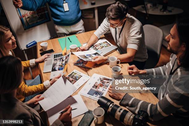 equipo de periodistas trabajando hasta tarde - newsroom fotografías e imágenes de stock