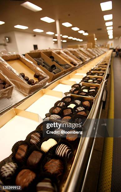 Boxes of chocolate sit on the prodcution line at the See's Candies Inc. Packing facility in South San Francisco, California, U.S., on Thursday, Dec....