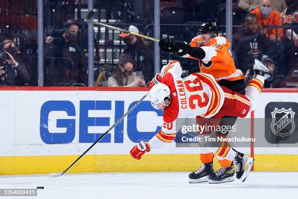 Rasmus Ristolainen of the Philadelphia Flyers and Blake Coleman of the Calgary Flames collide at Wells Fargo Center on November 16, 2021 in...
